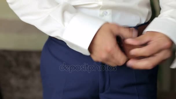 Man fastens the belt on his trousers, close-up. — Stock Footage Man fastens the belt on his trousers, close-up. Royalty Free Stock Video