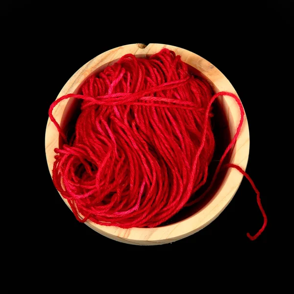 Ball of red wool in a wooden bowl from above — Stock Photo, Image