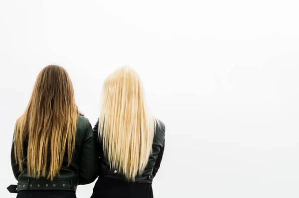 two young women stand a back. concept female friendship and feminism