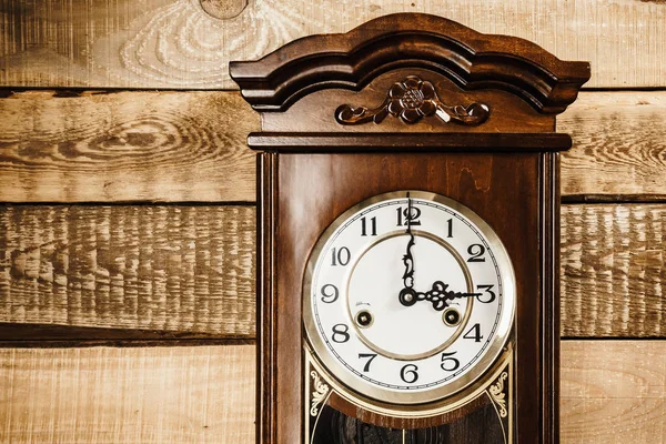 Old clock on a wooden wall — Stock Photo, Image