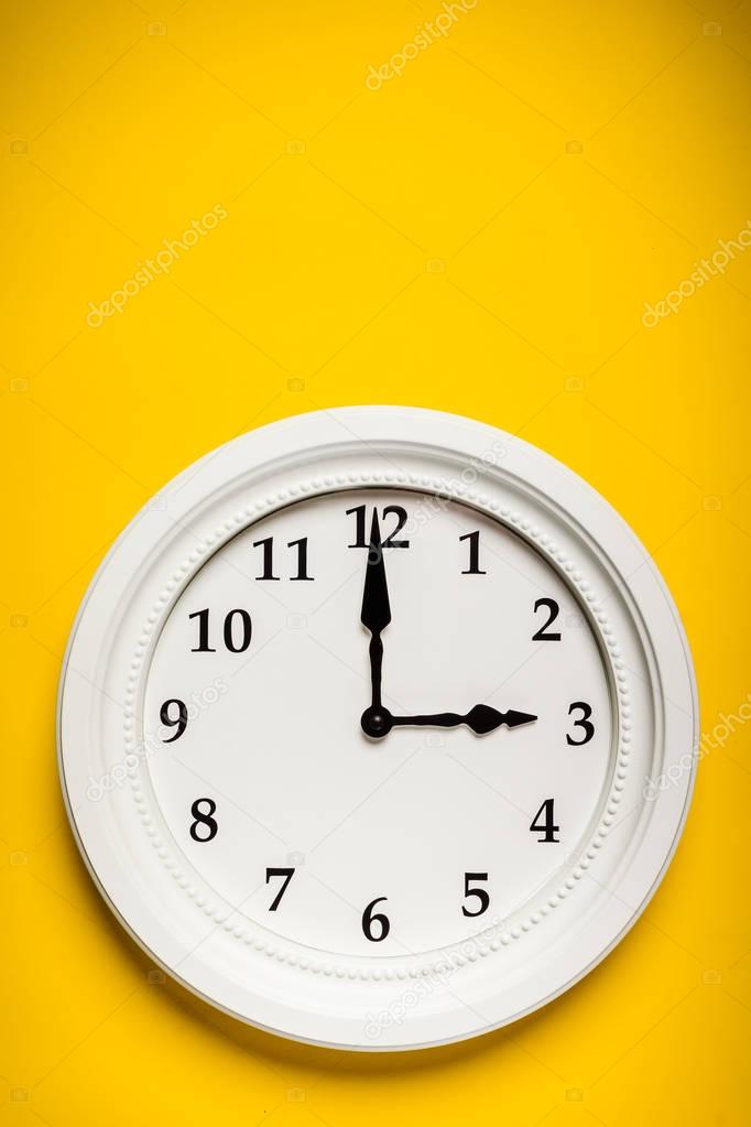 white clock on a yellow background