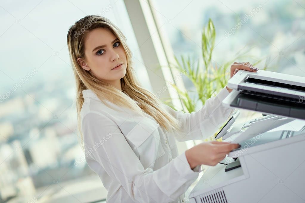 young businesswoman uses a scanner in a skyscraper office