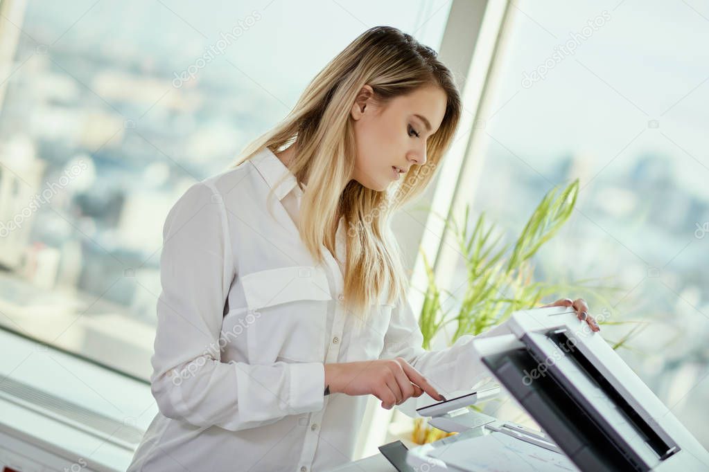 young businesswoman scans documents in the office