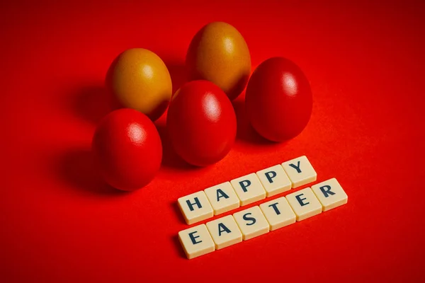 Colored eggs and text on a red background — Stock Photo, Image