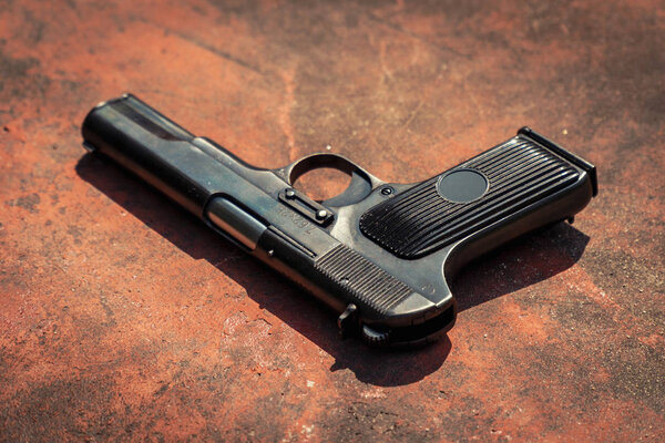 handgun on the concrete red backgroound