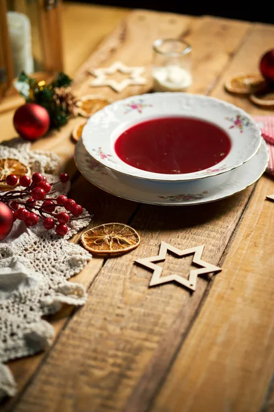 Traditional christmas red borscht on wooden table — Stock Photo, Image