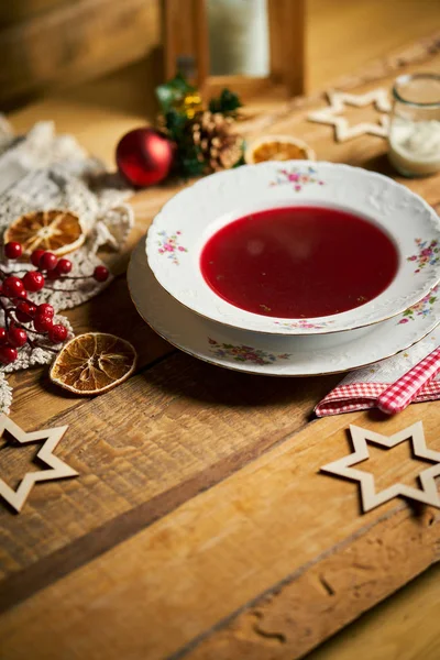 Traditional christmas red borscht on wooden table — Stock Photo, Image