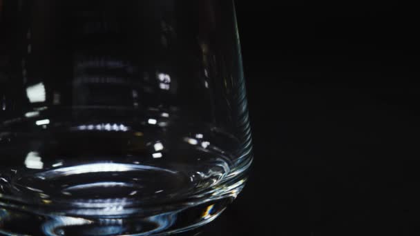 Two ice cubes fall into an empty glass — Stock Video