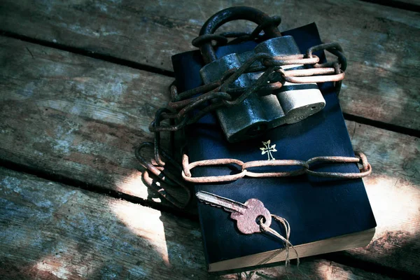 book locked with padlock and chains