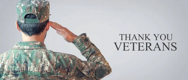 Caucasian Soldier Saluting Veterans Day.