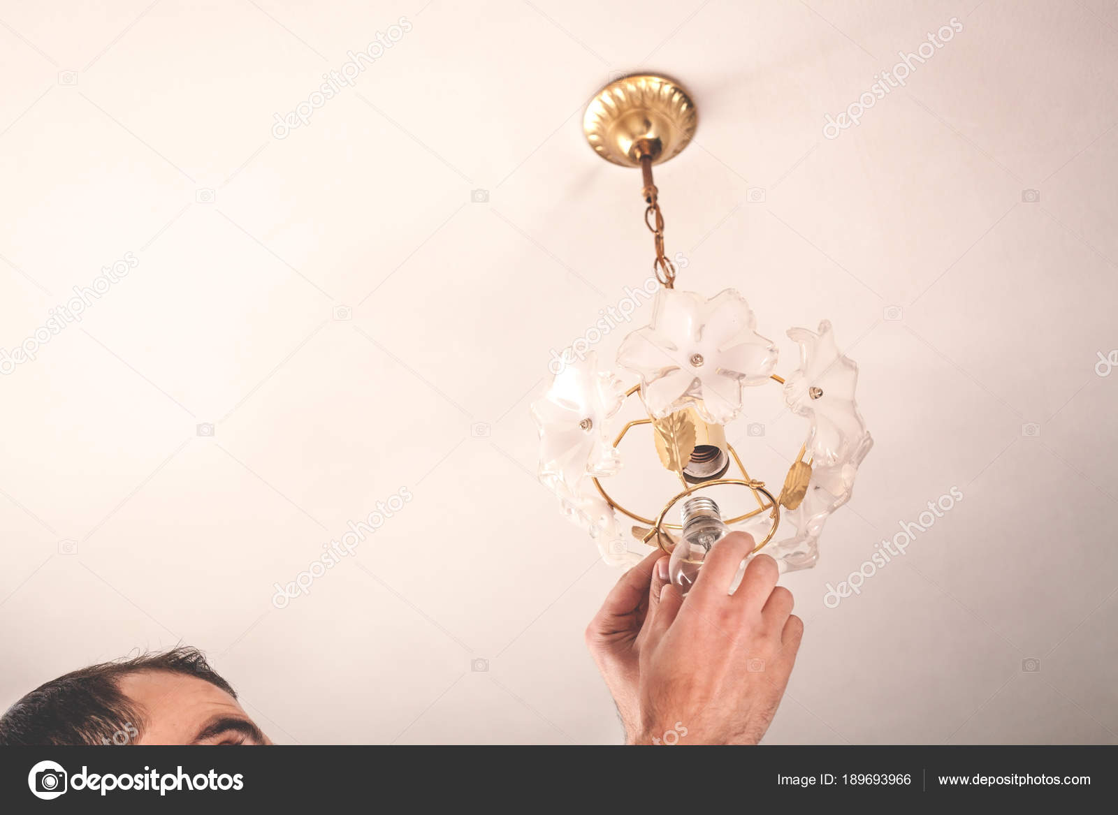 Electrician Man Changing Light Bulbs In Chandelier Stock Photo Electrician Man Changing Light Bulbs In Chandelier Stock Photo