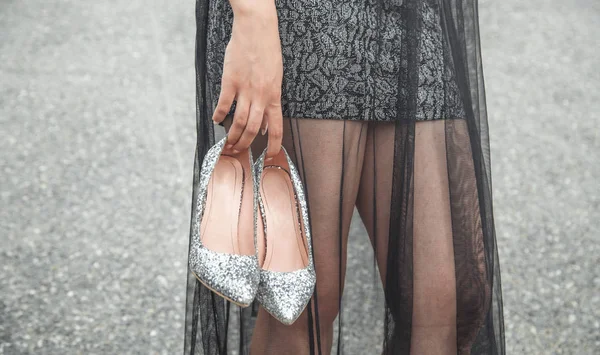 Egy fekete estélyi ruhás nő cipőben. Divat — Stock Fotó