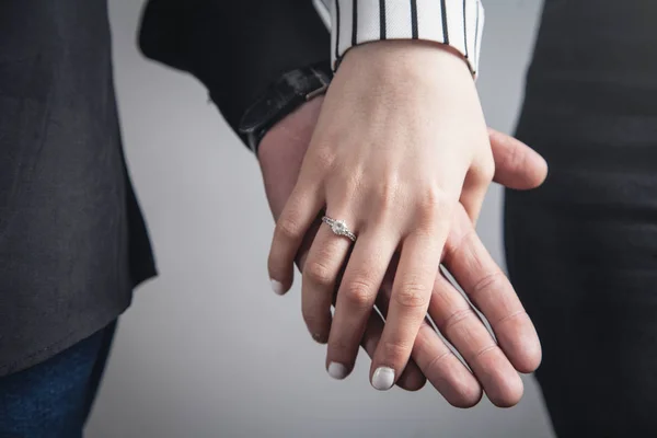 Hands of a guy and a girl with wedding ring. — Stock Photo, Image