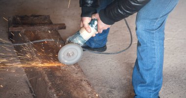 Adam metali öğütücüyle keser. Endüstriyel konsept