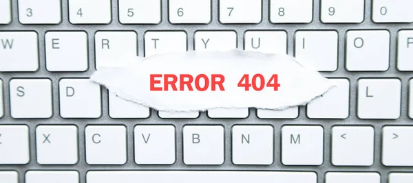 Error 404. Torn paper on computer keyboard