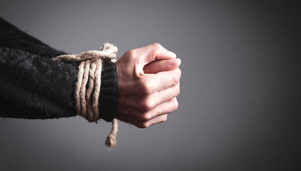 Hands tied with a rope. Concept of imprisonment