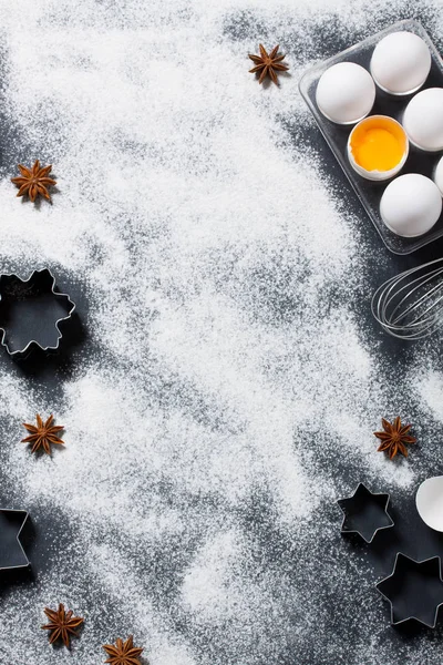 Baking background with eggs, whisk and star cookie cutters — Stock Photo, Image