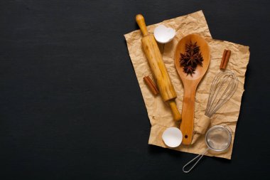 Arka plan üzerinde koyu renk ahşap mutfak aletleri ile pişirme