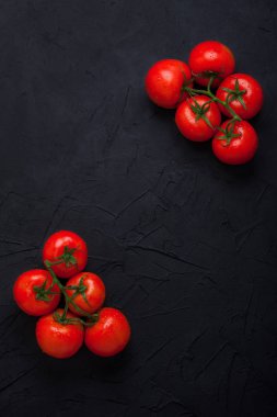 Siyah beton zemin üzerine kırmızı taze organik domates