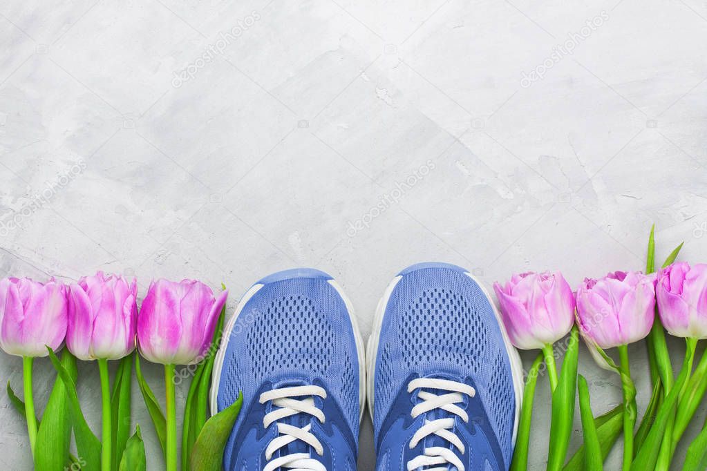 Spring flatlay sports composition with blue sneakers and purple 