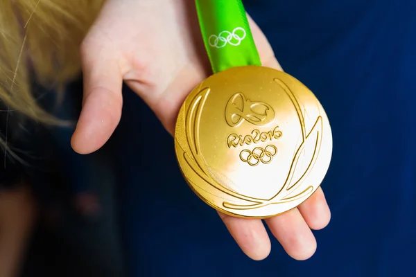 MOSCOW, RUSSIA - AUGUST 24, 2016: Meeting with the russian women handball team.Gold medals of Olympic Games in Rio demonstration. Gold medal's reverse