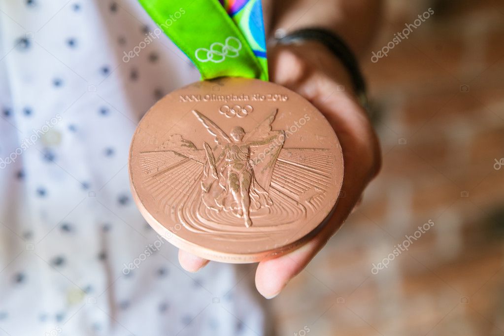 MOSCOW, RUSSIA - AUGUST 26, 2016: Meeting with the russian gymnast David Belyavskiy.Silver and bronze medals of Olympic Games in Rio demonstration. Bronze medal's obverse.