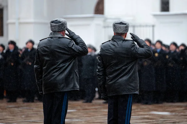 Two Russian army generals. Salutation. Back view. Winter view.