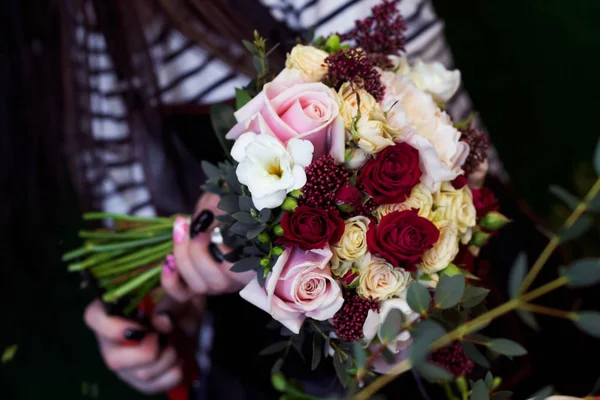 Florist makes bouquet for wedding.