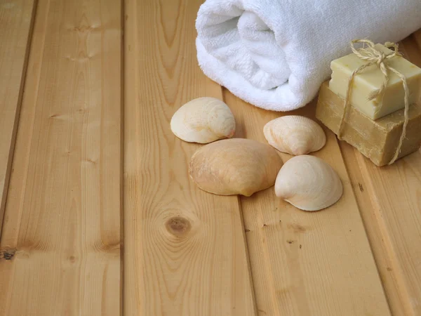 Towel,soap,and shells on the wooden background — Stock Photo, Image