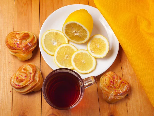 Tea with lemon and heart shaped buns — Stock Photo, Image