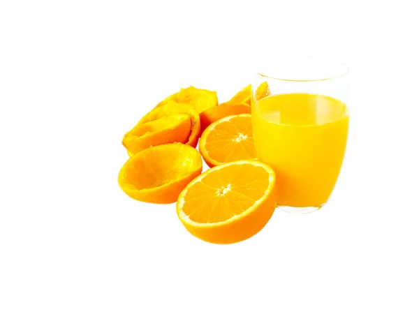 Fresh orange juice in the glass and orange fruits halves and pee — Stock Photo, Image