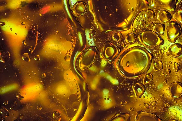 Абстрактные капли масла подсолнечника на золотом фоне . — стоковое фото