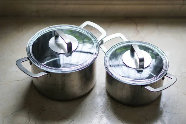 old aluminum stainless steel cooking pot on kitchen table