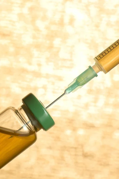 Medical ampoule with vaccine and syringe isolated on orange background — Stock Photo, Image