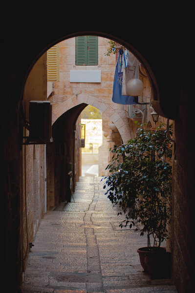 Alley with tree, arch and windows in Jerusalem old city, Israel