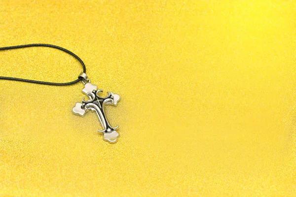 Close up cross pendant on glitter background with copy space — Stock Photo, Image