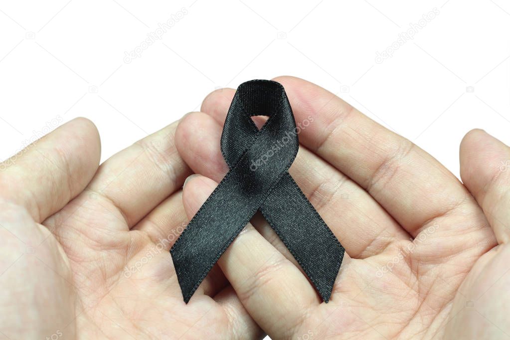 Hand holding black ribbon for mourning concept on white background 