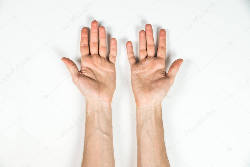 top view of hands of man on white table