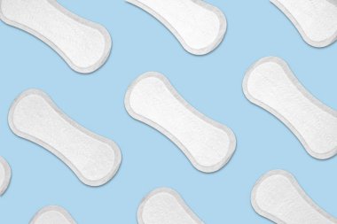 Female menstrual pads in blue background. clipart