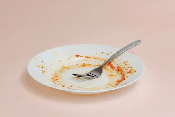 A plate with rests of tomato sauce in it — Stock Photo, Image