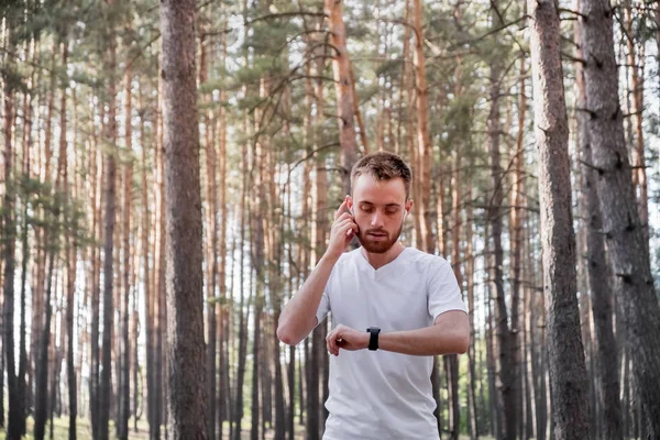 Young Man Checking Smart Watch Jogging Forest — Stock Photo, Image