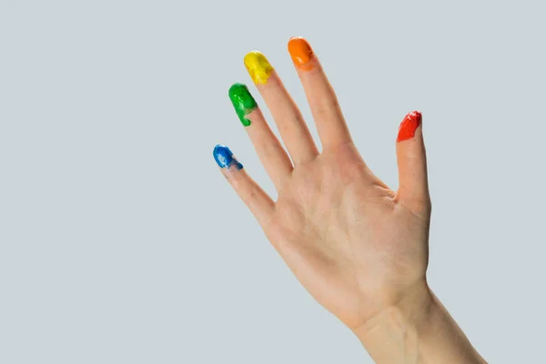 Close-up view of a hand with paint on the fingertips. — ストック写真