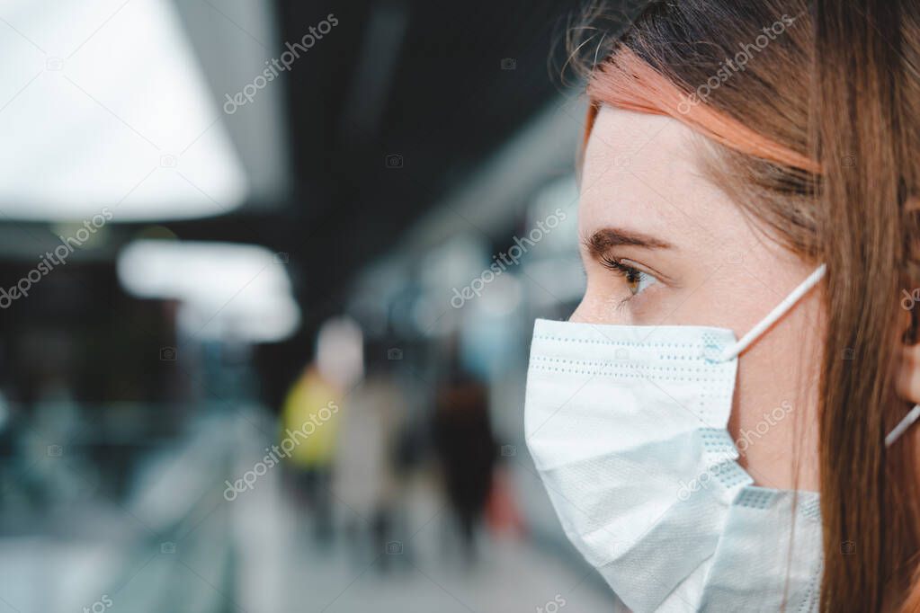 Porrait of a female person with face mask at a public place. Coronavirus, COVID-19 spread prevention concept, responsible social behaviour of a citizen