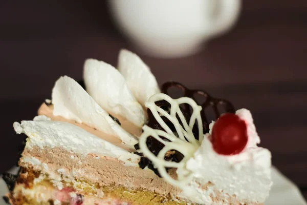 Cake with cream and cherry on a dark background — Stock Photo, Image