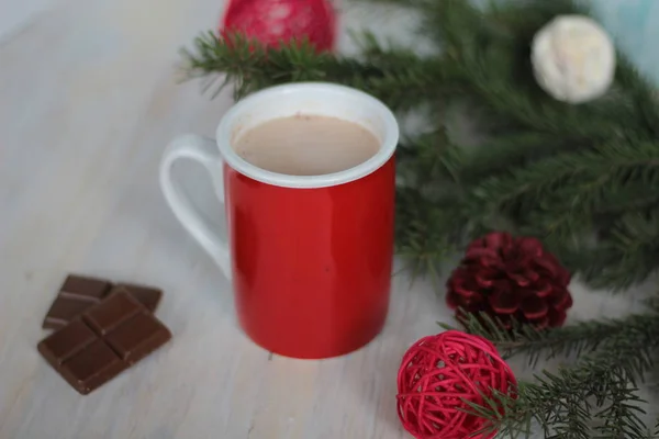 Mug filled with hot chocolate and christmas tree — Stock Photo, Image