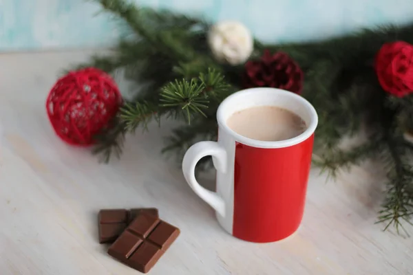 Cup of hot chocolate and christmas tree branch — Stock Photo, Image