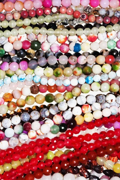 Many necklaces in plastic beads