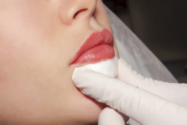 Doctor dermatologist performs Contour plastic and  infill