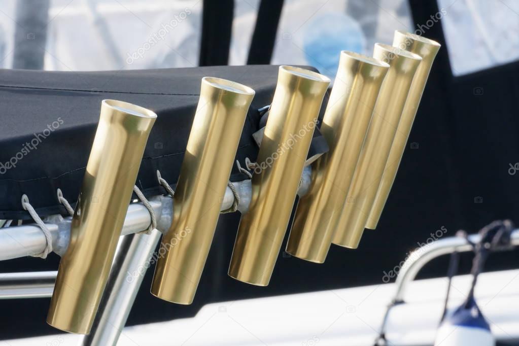 Several chrome rod holders in a fishing boat