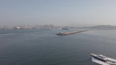 Cagliari, İtalya - 20 Eylül 2019: Sardunya bölgesindeki yavaş yavaş Cagliari limanına yaklaşan feribot, dalgakıranın manzarası ve farları ve bir pilot sürat teknesi iskeleye doğru yol alıyor.